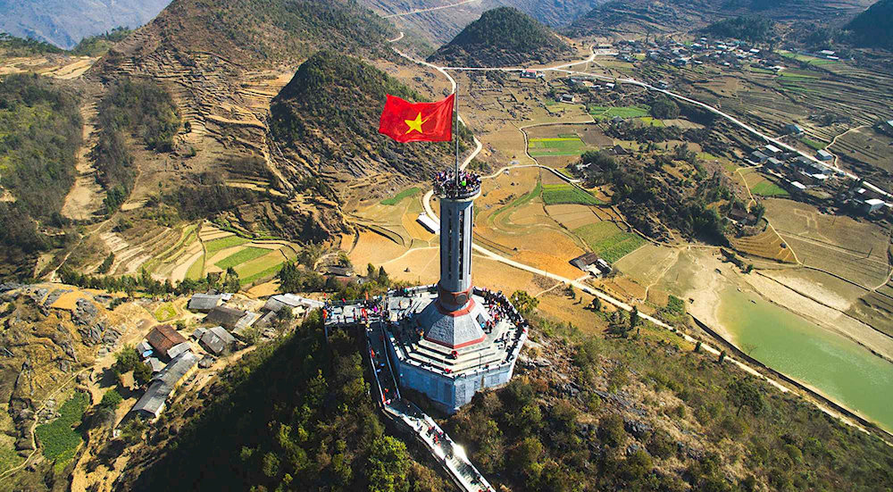 Panoramic view of Lung Cu flagpole with the red flag with a yellow star fluttering in the sky
